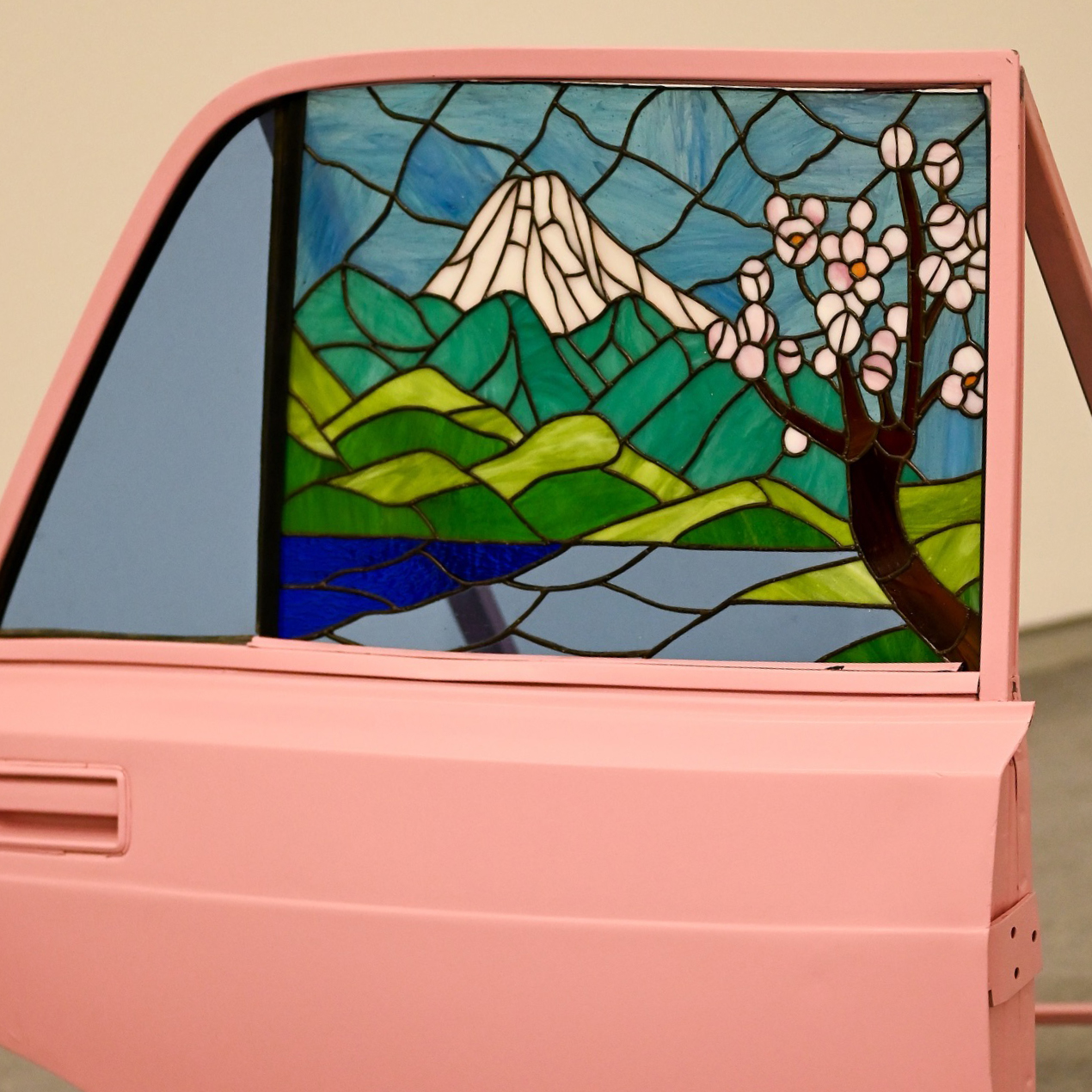 Untitled. Stained glass, recycled car door, spray paint. 2025. Exhibition view.